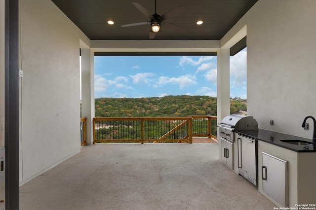 view of patio with ceiling fan, area for grilling, grilling area, and sink