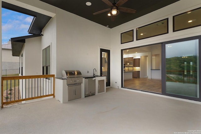 view of patio / terrace with ceiling fan, a grill, and sink