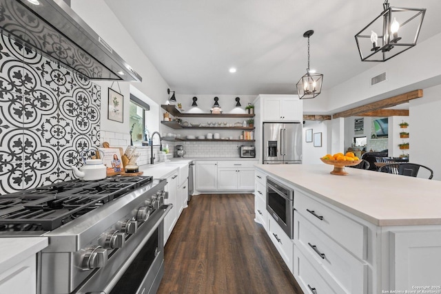 kitchen featuring high quality appliances, visible vents, open shelves, and light countertops