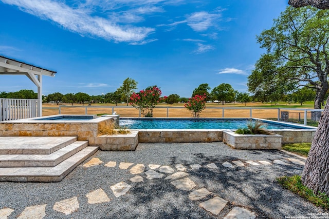 outdoor pool featuring an in ground hot tub