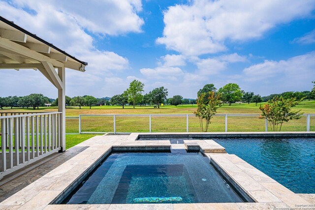 view of swimming pool featuring a yard and a pool with connected hot tub