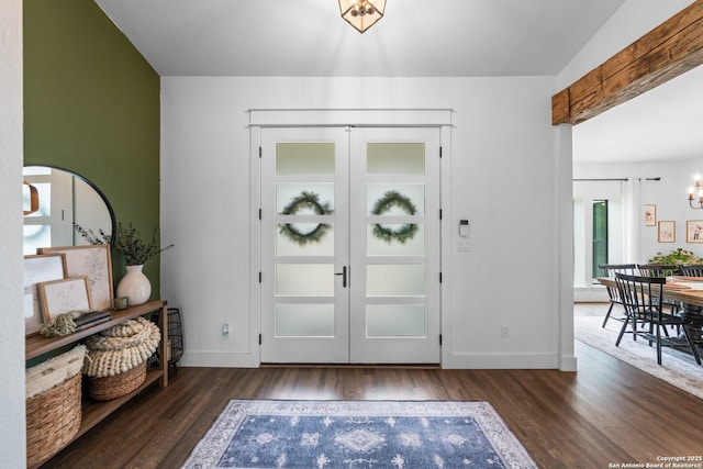 entrance foyer with an inviting chandelier, baseboards, wood finished floors, and french doors