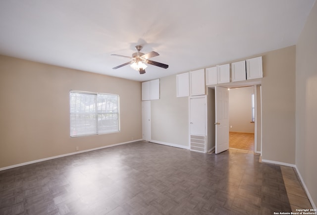 unfurnished bedroom featuring dark parquet floors and ceiling fan