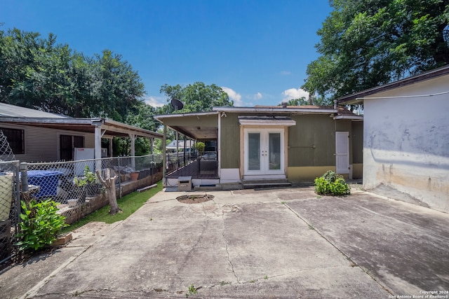 rear view of property featuring a patio area and french doors