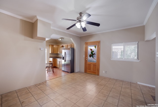 interior space with ceiling fan and crown molding