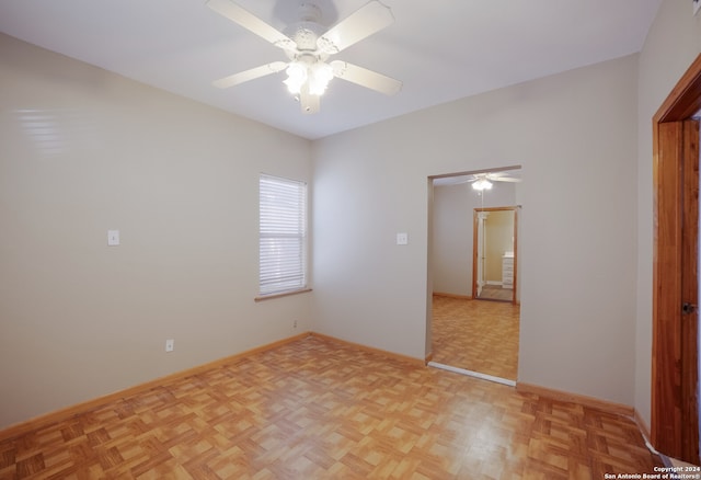 unfurnished room featuring ceiling fan and light parquet floors