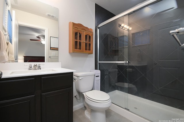 bathroom featuring tile patterned floors, ceiling fan, toilet, and a shower with shower door