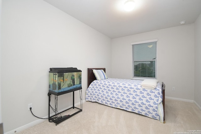 bedroom featuring light colored carpet