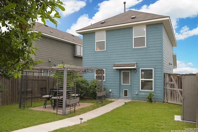 rear view of property featuring a lawn