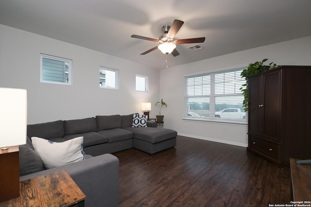 living room with dark hardwood / wood-style flooring, ceiling fan, and plenty of natural light