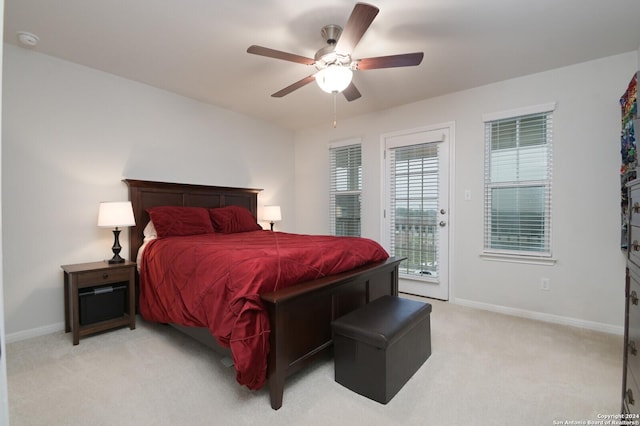 bedroom featuring light carpet, access to outside, and ceiling fan