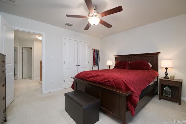 carpeted bedroom featuring ceiling fan and a closet