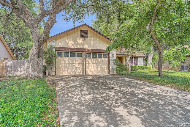 view of front of property featuring a garage and central AC