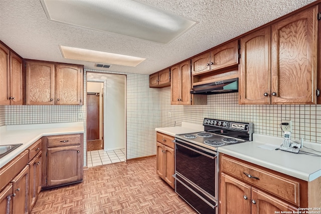 kitchen featuring backsplash, range with electric cooktop, extractor fan, and a textured ceiling