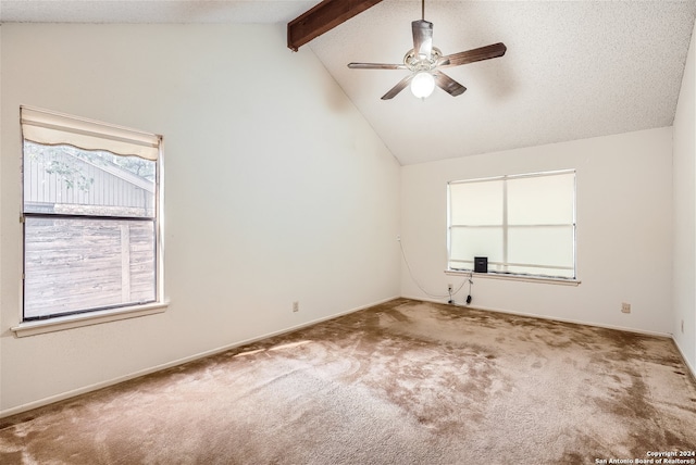 carpeted empty room with lofted ceiling with beams and ceiling fan