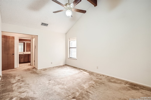 unfurnished bedroom with light carpet, connected bathroom, high vaulted ceiling, and ceiling fan