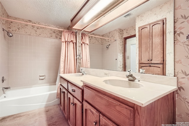 bathroom featuring vanity, shower / bath combination with curtain, and a textured ceiling