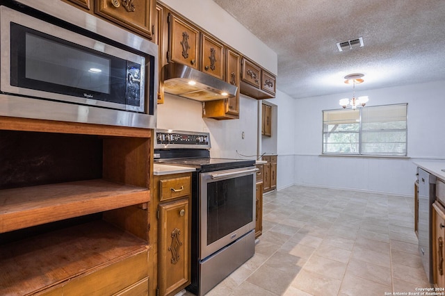 kitchen featuring a chandelier, pendant lighting, a textured ceiling, and stainless steel appliances