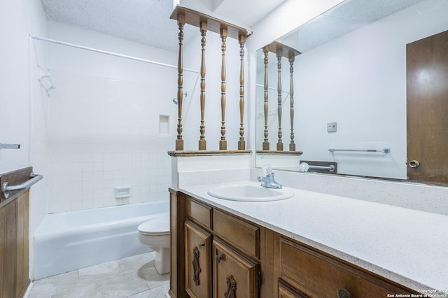 full bathroom featuring vanity, tile patterned floors, tiled shower / bath combo, toilet, and a textured ceiling