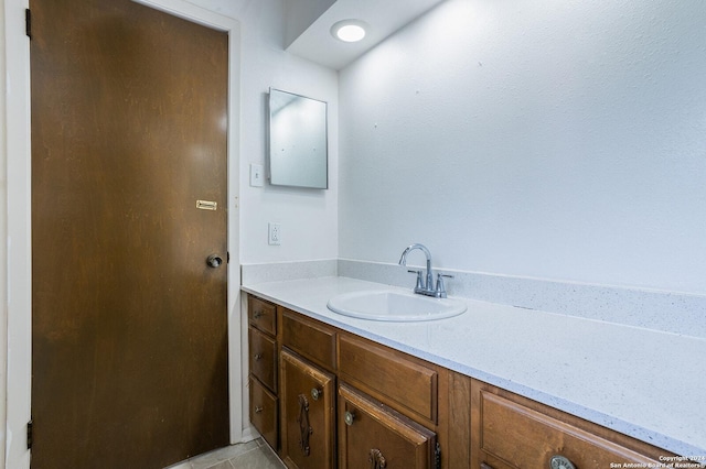 bathroom with tile patterned flooring and vanity