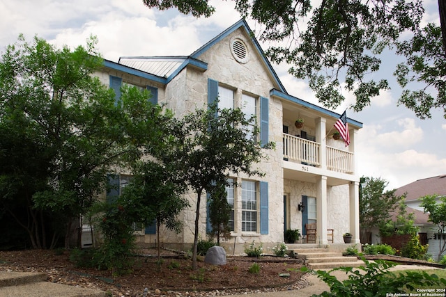 view of front of house featuring a balcony