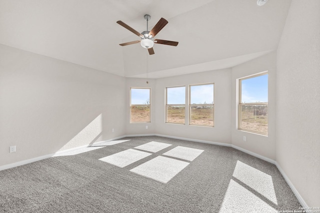 carpeted spare room featuring baseboards, lofted ceiling, and a ceiling fan