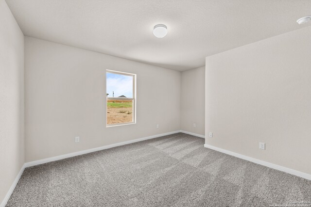 empty room with baseboards and carpet floors