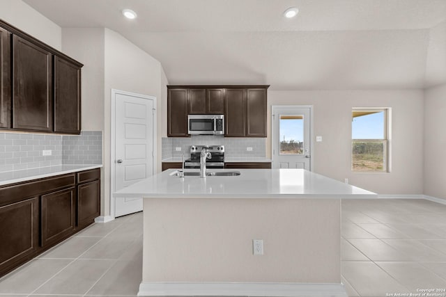 kitchen featuring a sink, appliances with stainless steel finishes, light tile patterned flooring, and light countertops