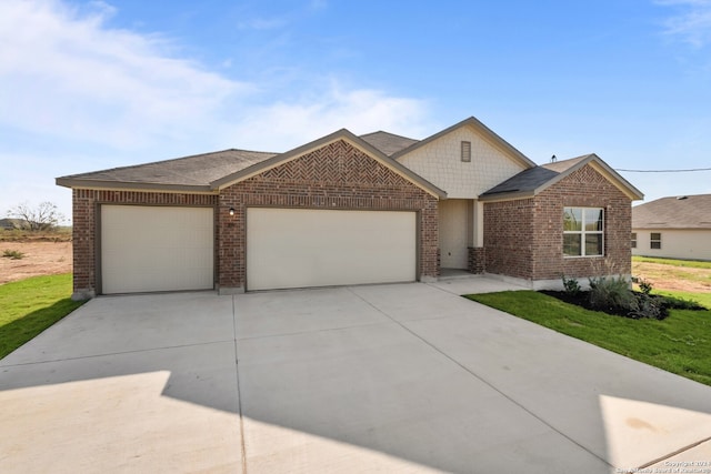 view of front of house featuring brick siding, concrete driveway, roof with shingles, a front yard, and an attached garage