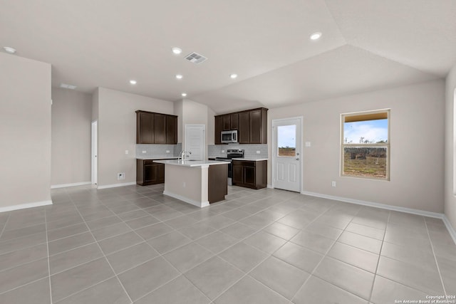 kitchen with visible vents, appliances with stainless steel finishes, open floor plan, and light countertops