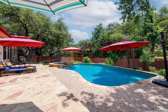 view of swimming pool featuring an in ground hot tub and a patio