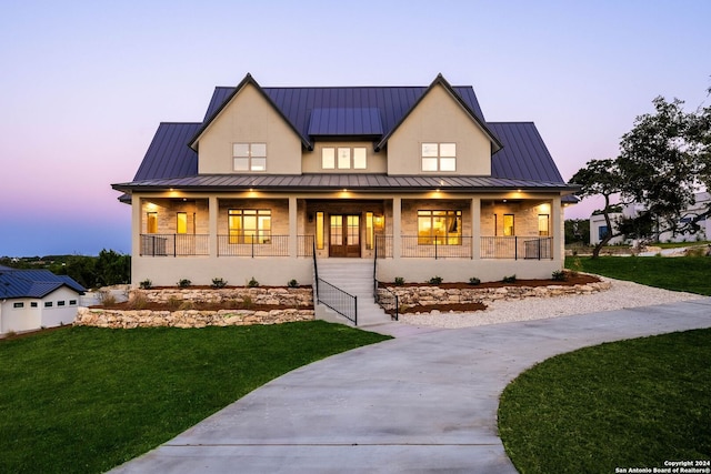 modern farmhouse featuring a yard and covered porch