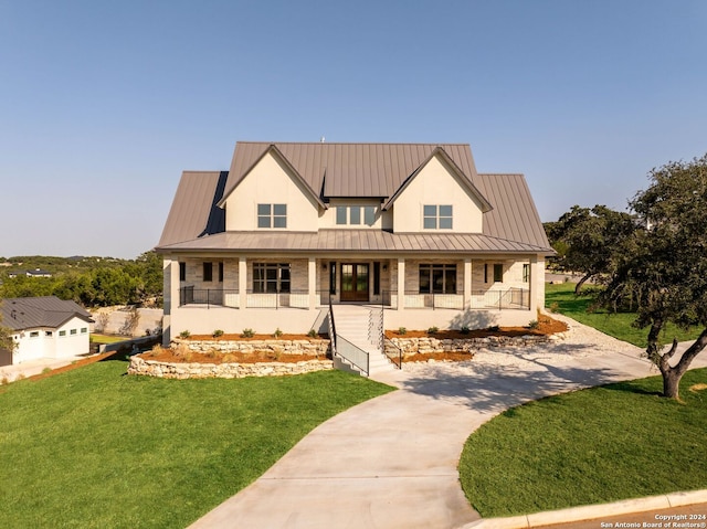 modern inspired farmhouse with a front yard and a porch