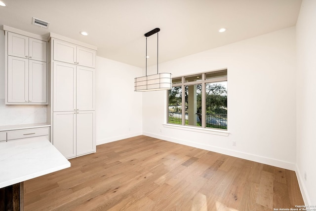 unfurnished dining area with light hardwood / wood-style flooring