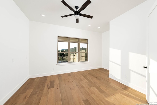 spare room featuring light hardwood / wood-style floors and ceiling fan