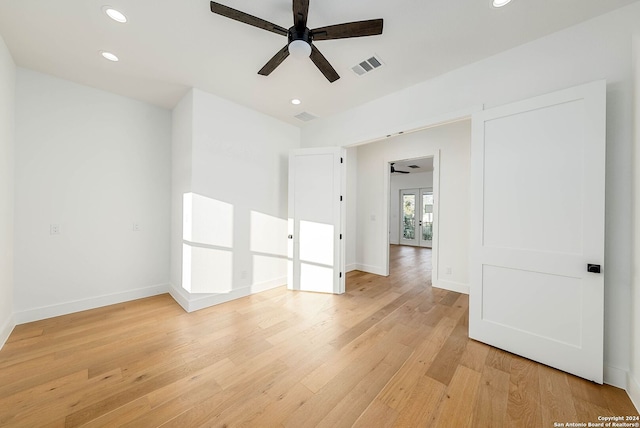 empty room with light hardwood / wood-style floors and ceiling fan