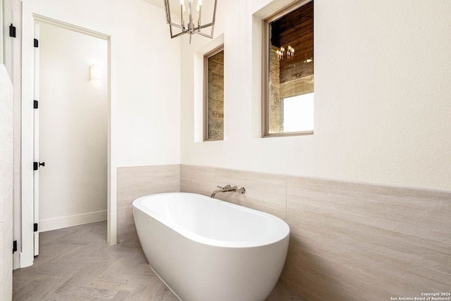 bathroom featuring tile walls and a washtub