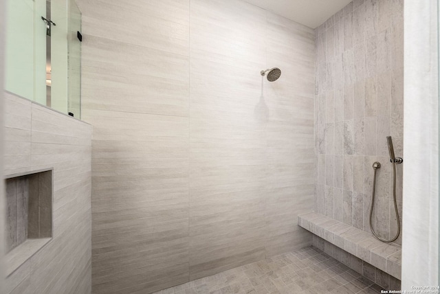 bathroom featuring tile walls and tiled shower