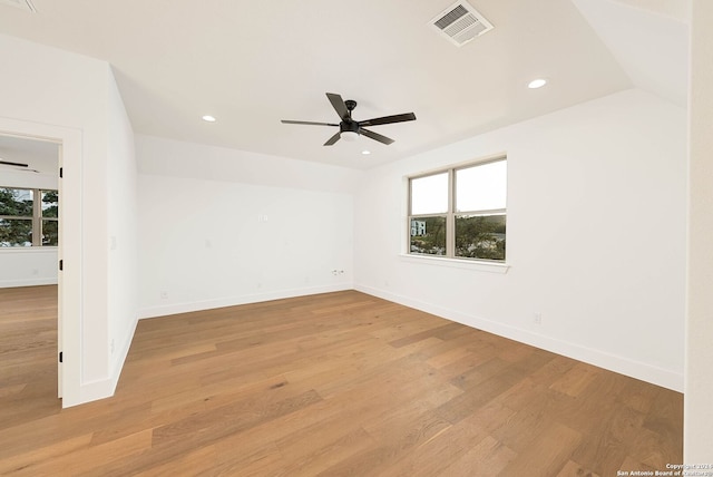 empty room featuring light hardwood / wood-style floors, a healthy amount of sunlight, lofted ceiling, and ceiling fan