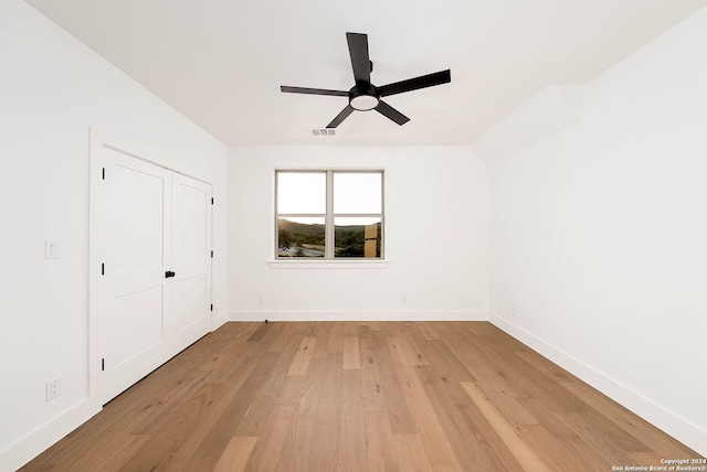 unfurnished bedroom featuring a closet, ceiling fan, and light wood-type flooring