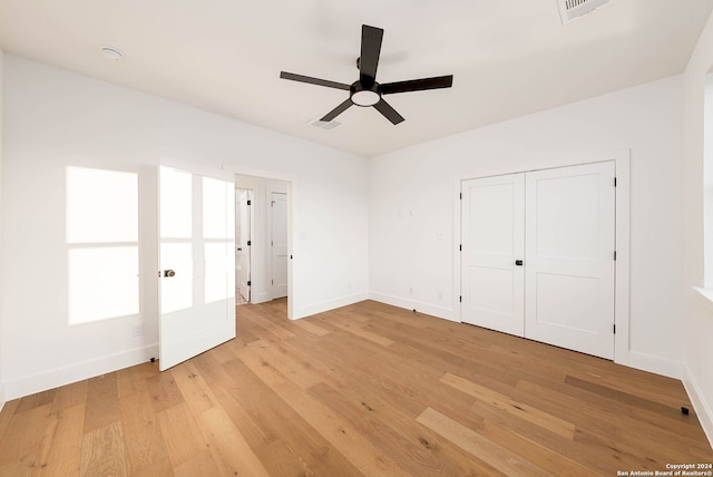 unfurnished bedroom with a closet, ceiling fan, and light hardwood / wood-style flooring