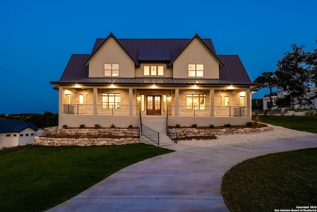 modern farmhouse with covered porch and a front yard