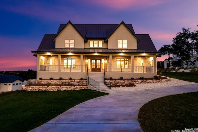 modern farmhouse with covered porch and a yard