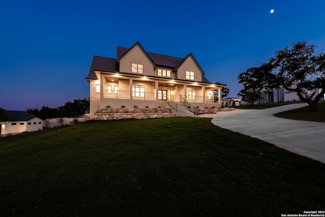 view of front of house with a lawn and a porch