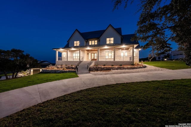 view of front of house with a porch and a lawn