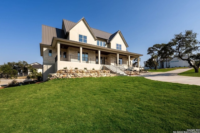 view of front of home with a front yard and a porch