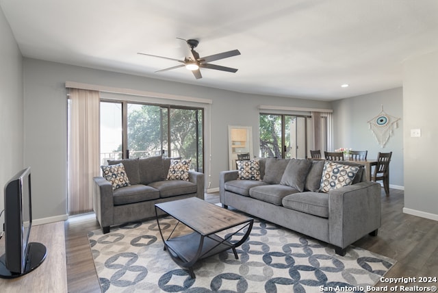 living area with ceiling fan, baseboards, wood finished floors, and recessed lighting