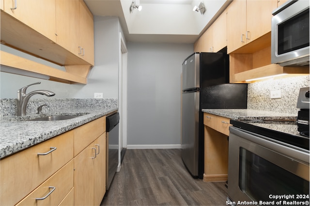 kitchen featuring light brown cabinets, sink, dark hardwood / wood-style floors, light stone countertops, and stainless steel appliances