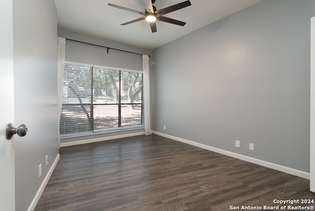 empty room with dark hardwood / wood-style floors and ceiling fan