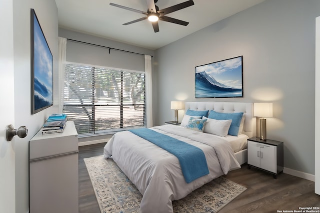 bedroom with ceiling fan and dark wood-type flooring